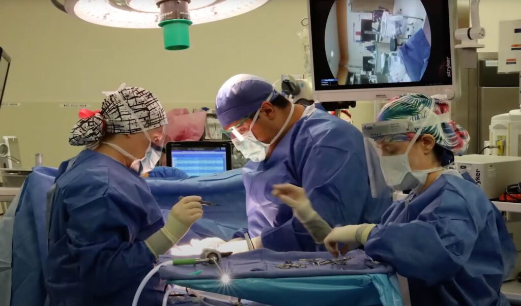 residents and surgeon in operating room
